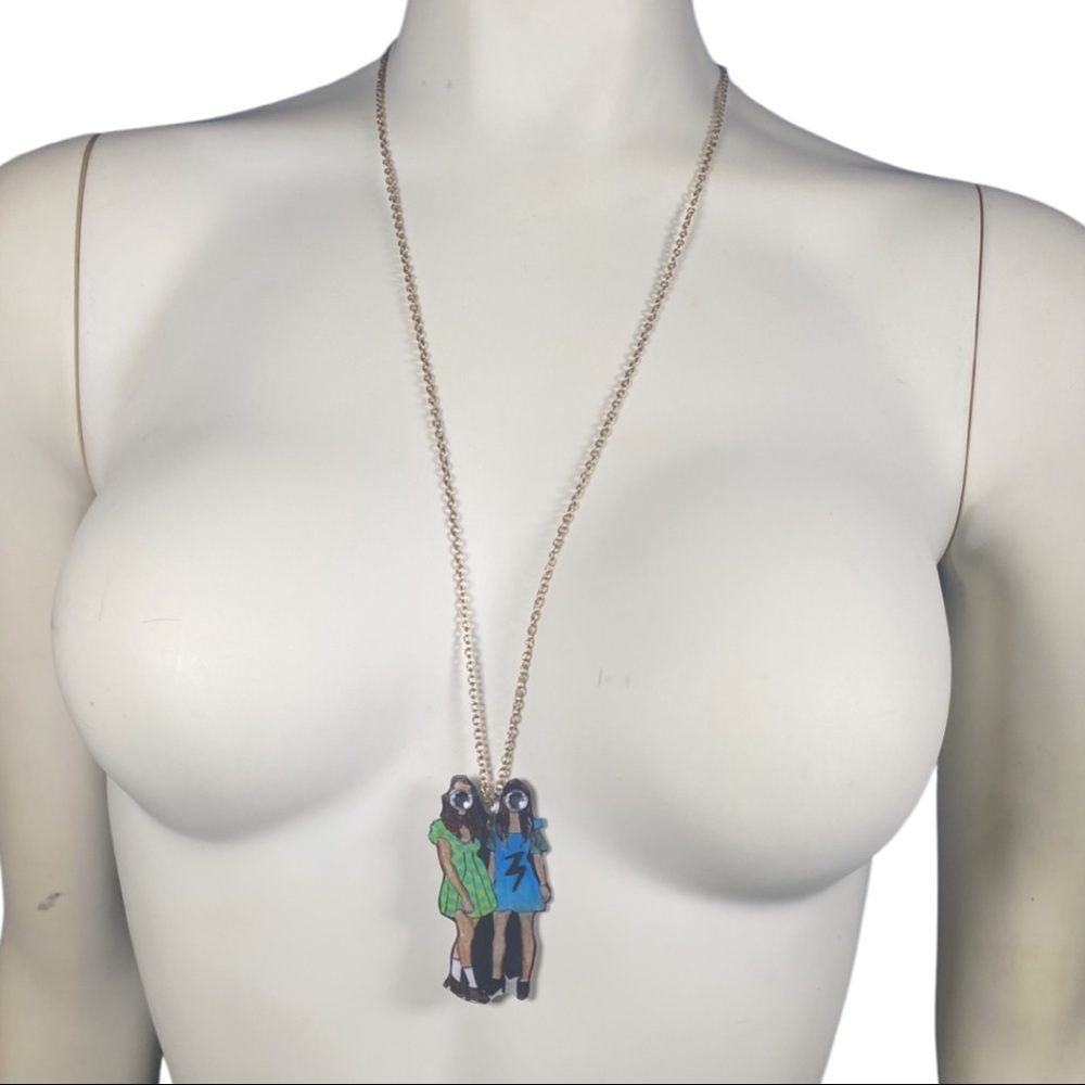 Two stylish girls with rhinestone faces wearing dresses pendant necklace